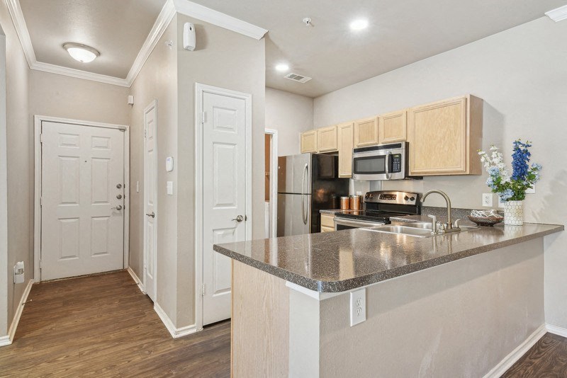 a kitchen with a granite counter top  at Legends on the Green Apartments, Texas
