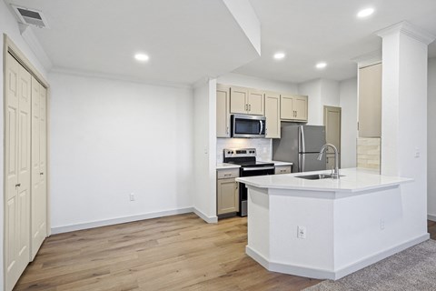 a white kitchen with a large island and a stainless steel at The Legends at Eagle Mountain Lake, Fort Worth, TX