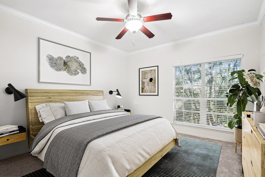 a bedroom with a bed and a ceiling fan at La Ventura Apartments, Texas, 75093