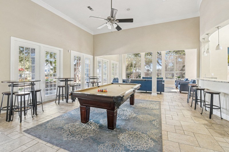 a game room with a pool table and a bunch of chairs at TalaVera Apartments, San Antonio, TX, 78232