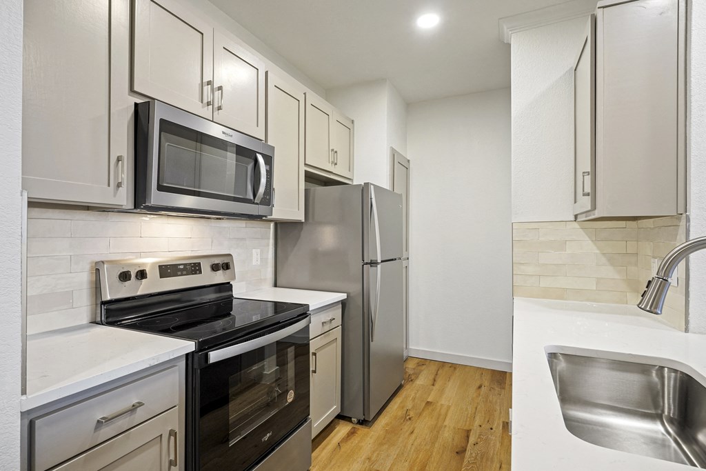 a kitchen with stainless steel appliances and white cabinets at The Legends at Eagle Mountain Lake, Fort Worth, TX, 76179