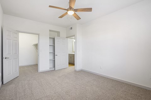 an empty bedroom with a ceiling fan and a closet at The Legends at Eagle Mountain Lake, Fort Worth, TX