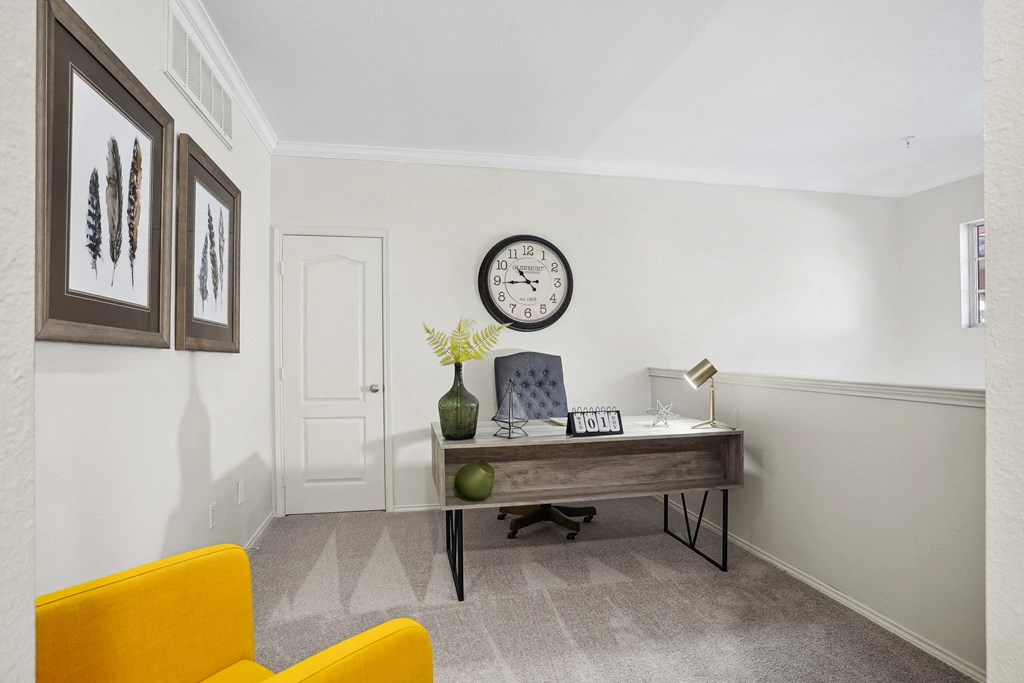 a home office with a desk and a clock on the wall at La Ventura Apartments, Plano, TX, 75093
