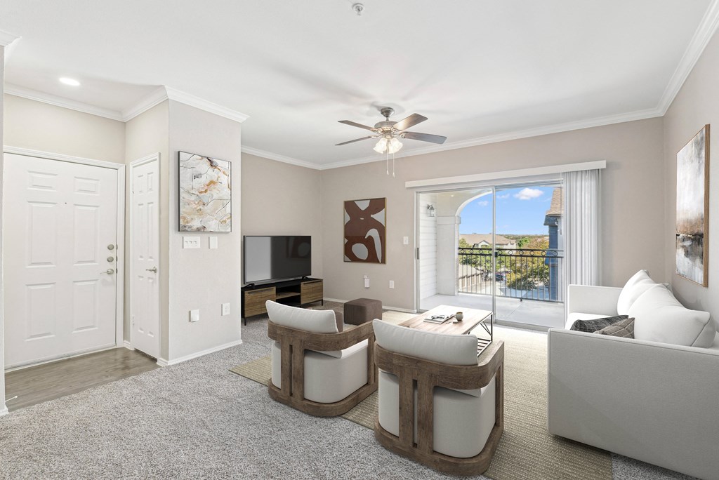 a living room with white furniture and a ceiling fan at TalaVera Apartments, San Antonio 78232
