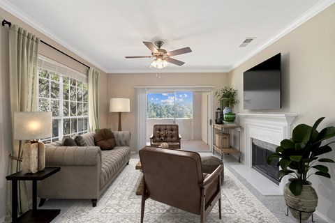 a living room with couches and chairs and a tv