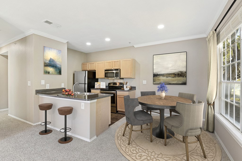 a living room with a kitchen and a dining area with a table and chairs at Legends on the Green Apartments, San Antonio, TX, 78232