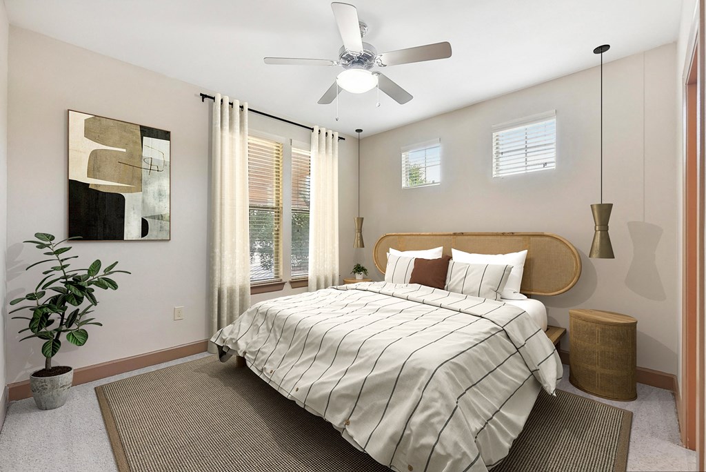 a bedroom with a large bed and a ceiling fan at Lakeline East Apartments, Texas, 78613