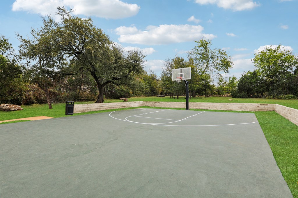 a basketball court in a park with trees at Ventana Oaks Apartments, Texas, 78717