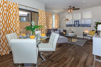 a living room and dining room with a table and chairs at The Preserve by Picerne, N Las Vegas, Nevada
