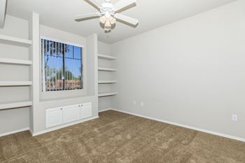 an empty living room with carpet and a ceiling fan at The Aliante by Picerne, Scottsdale, Arizona