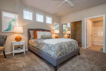 a bedroom with a bed and a closet and a ceiling fan at The Passage by Picerne, Henderson, 89014