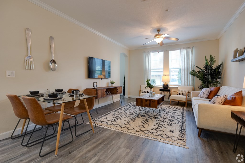 A living room with a dining table and chairs.