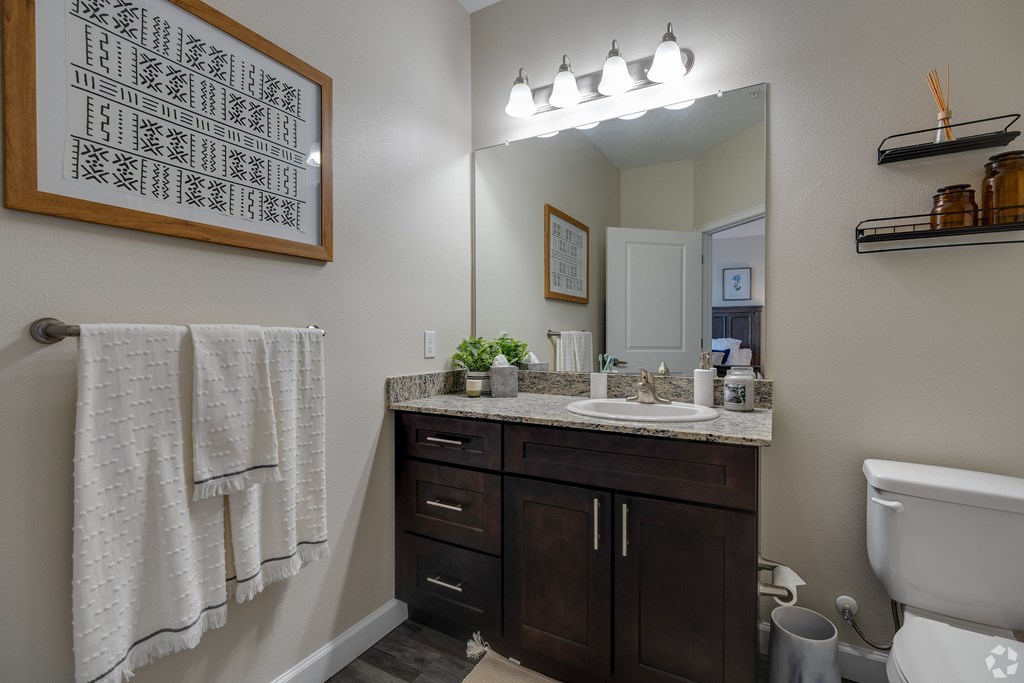 A bathroom with a white towel hanging on the wall.