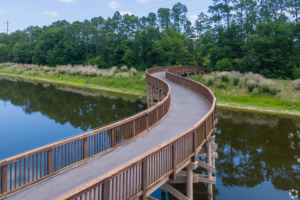 A wooden walkway curves around a body of water.