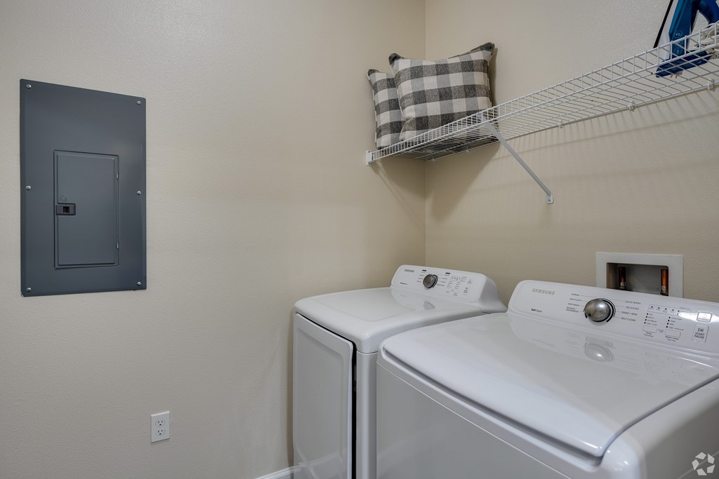 A small laundry room with a washer and dryer.