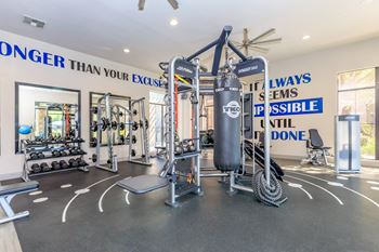 a home gym with weights and cardio equipment and a wall with a quote on it at The Preserve by Picerne, N Las Vegas