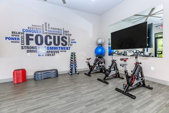 a fitness room with exercise bikes and a tv at The Preserve by Picerne, Nevada