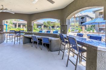 patio bar with seating and tables with umbrellas at The Preserve by Picerne, Nevada