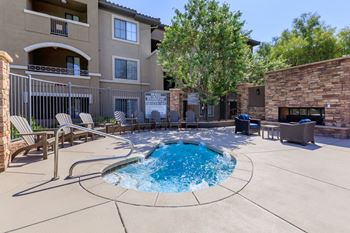 pool and hot tub with chairs and a building at The Preserve by Picerne, N Las Vegas, Nevada