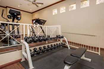 the gym with weights and equipment at 1861 muleshoe road at The Fairways by Picerne Apartments, Las Vegas 89141