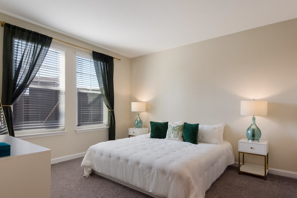 a bedroom with a white bed and green pillows  at The Oasis at Manatee River, Florida
