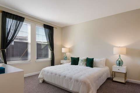 a bedroom with a white bed and green pillows  at The Oasis at Manatee River, Florida