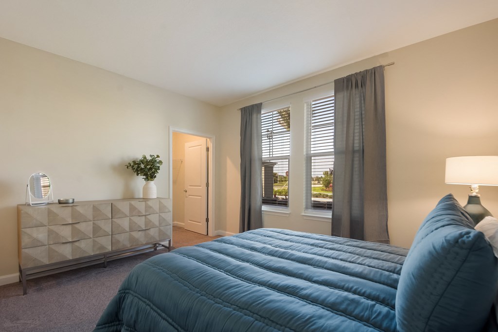 a bedroom with a large bed and two windows  at The Oasis at Manatee River, Florida, 34211