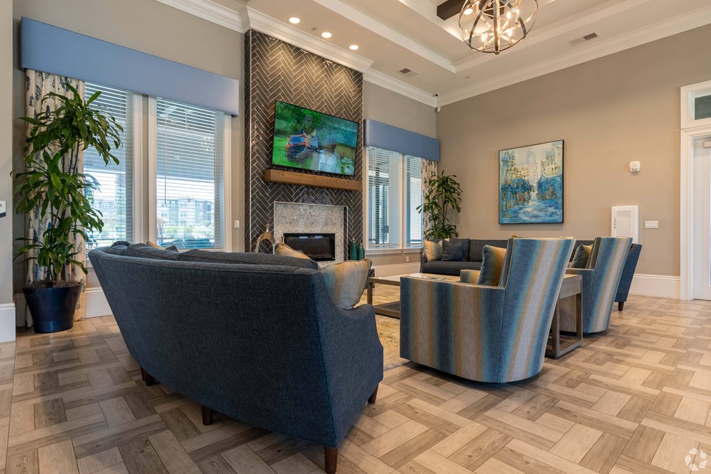 A living room with a grey sofa and a fireplace.