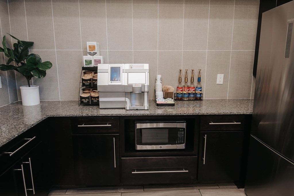 Gourmet coffee station with coffee and tea options and syrups.