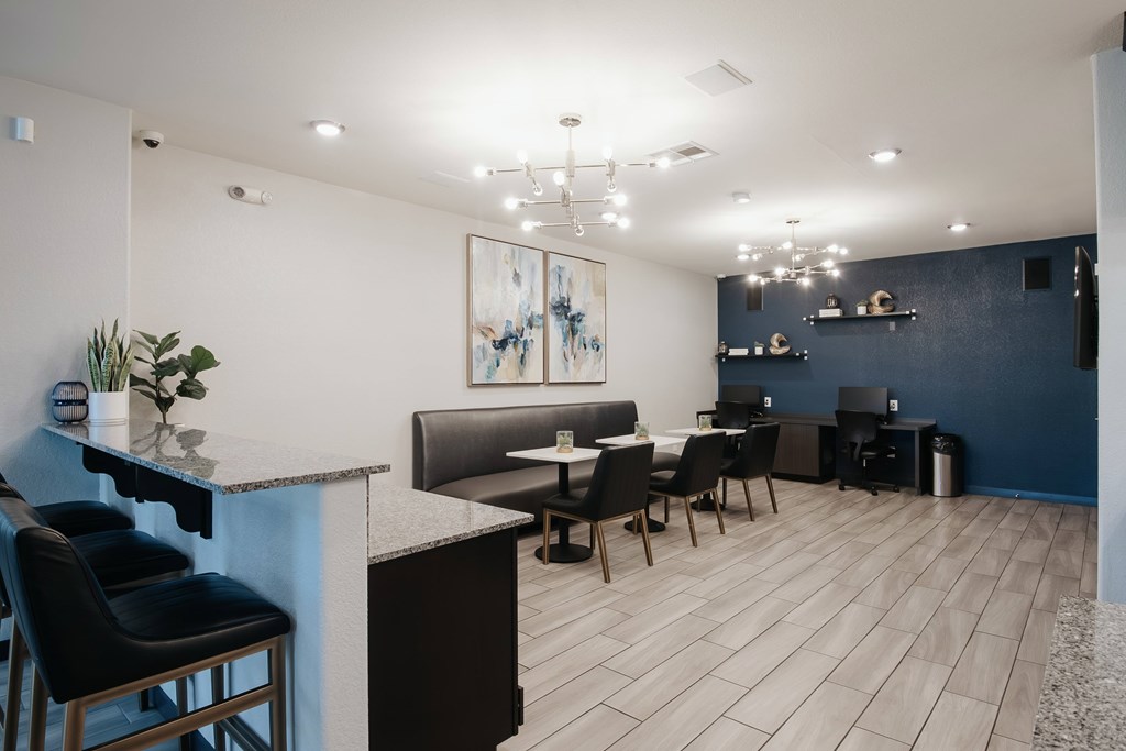 Business center area with two computers, cafe seating, and internet bar.