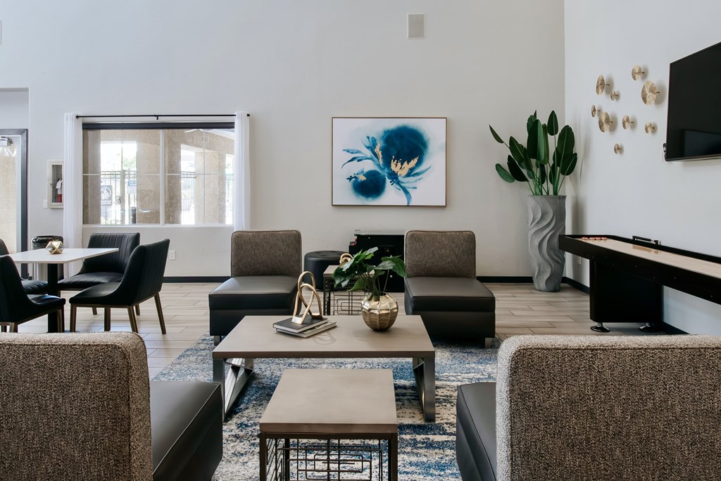 Comfortable clubhouse with seating, TV, and  shuffle board.