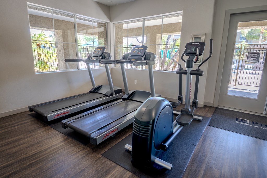 Treadmills and an elliptical machines in the gym.