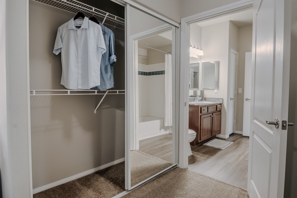 A white closet with a shirt hanging on it.