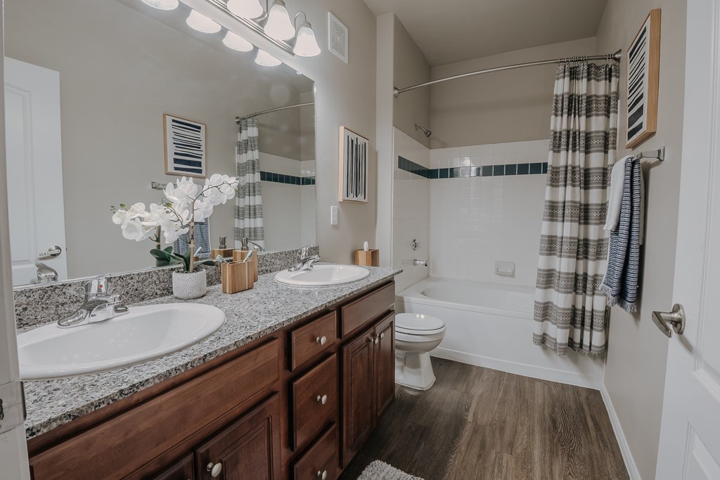 A bathroom with a white sink, a white toilet, and a white bathtub.