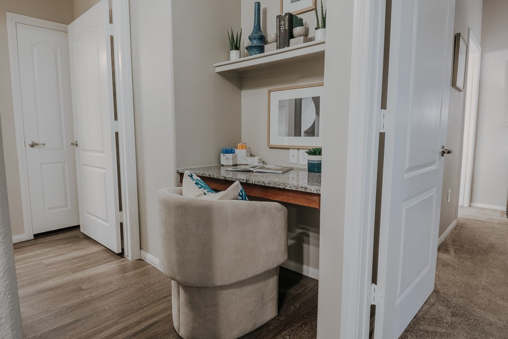 A room with a vanity table and a chair.