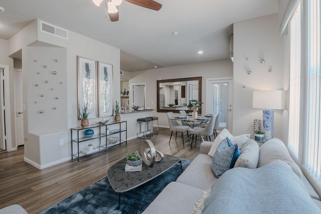 A modern living room with a grey sofa and a coffee table.