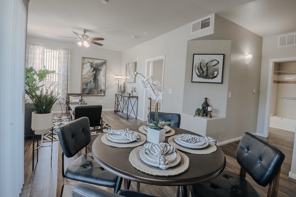 A dining room with a round table set for four.
