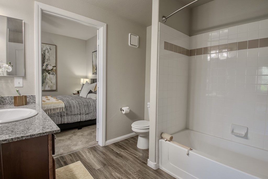 A bathroom with a toilet, sink, and bathtub.