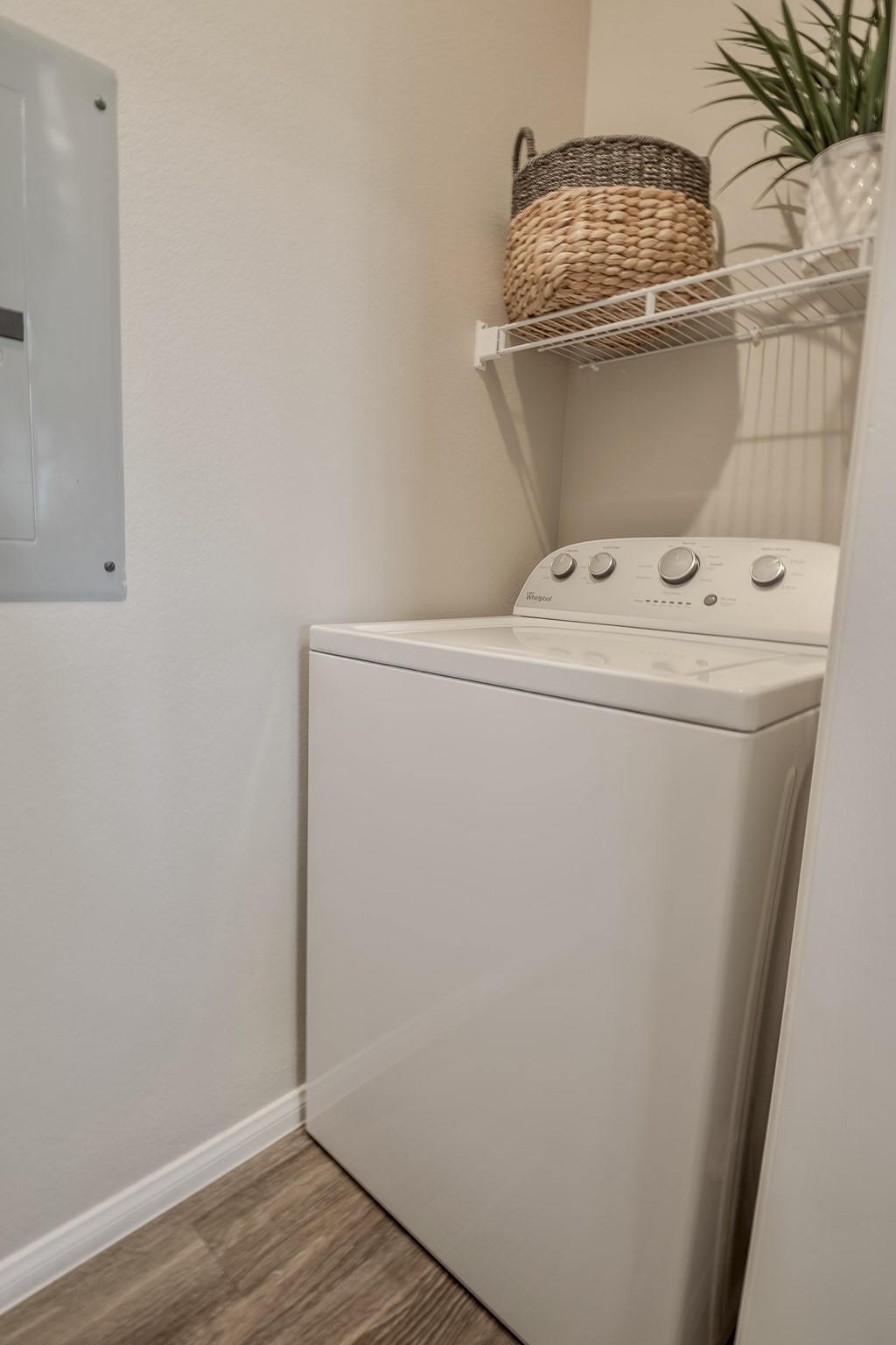 A white washing machine in a laundry room.