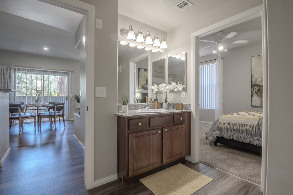 A well-lit, spacious bathroom with a vanity and a large mirror.