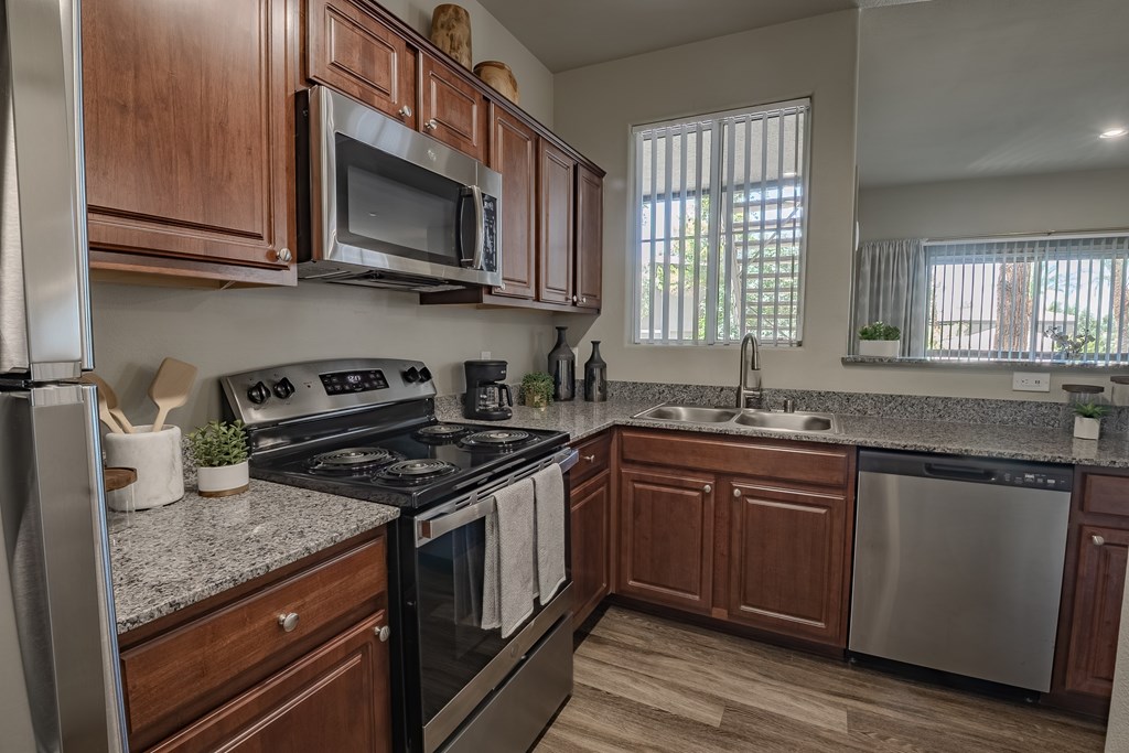 A kitchen with wooden cabinets and stainless steel appliances.