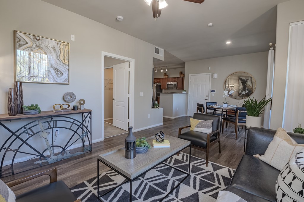 A living room with a black and white rug and a coffee table.