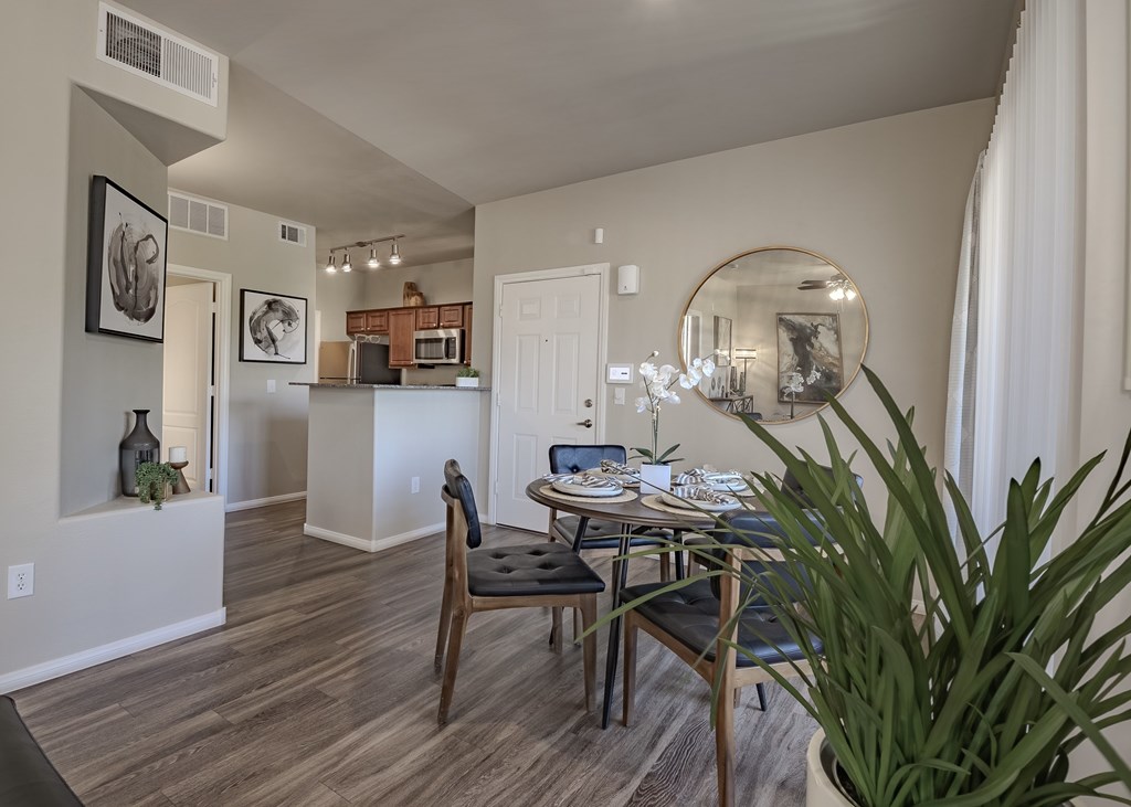A dining room with a wooden table and chairs.