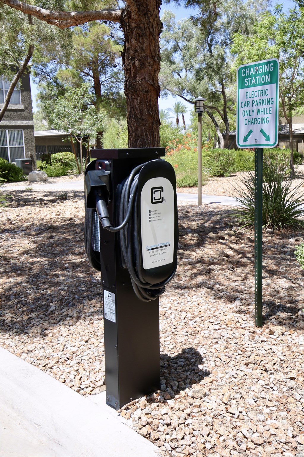 A charging station for electric cars is located in a parking area.