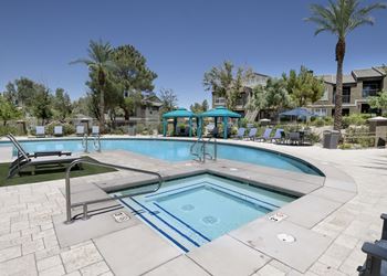 A swimming pool with a blue pool ladder and a blue pool cover.