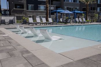 Swimming Pool With Lounge Chairs at Level 25 at The Curve by Picerne, Nevada