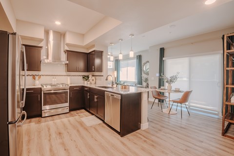 A modern kitchen with wooden floors and a large island.