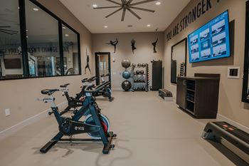 Spacious fitness center with cardio machines and weights at Level 25 at The Curve by Picerne, Nevada , 89148