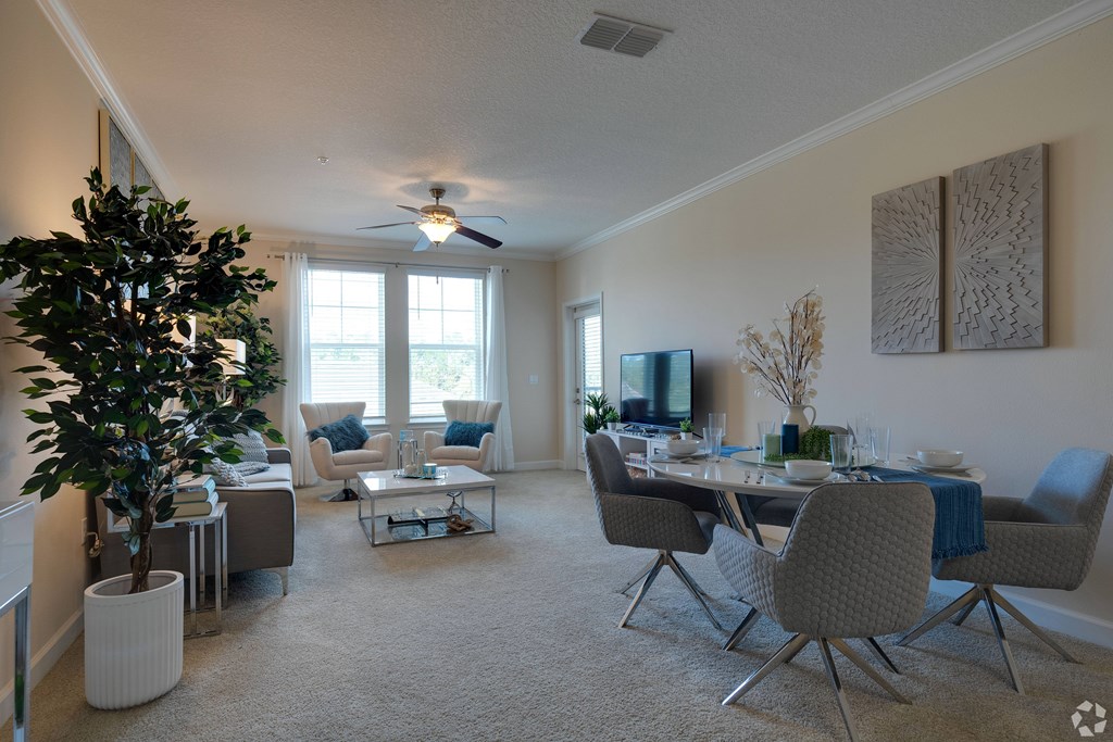 A living room with a dining table and chairs.