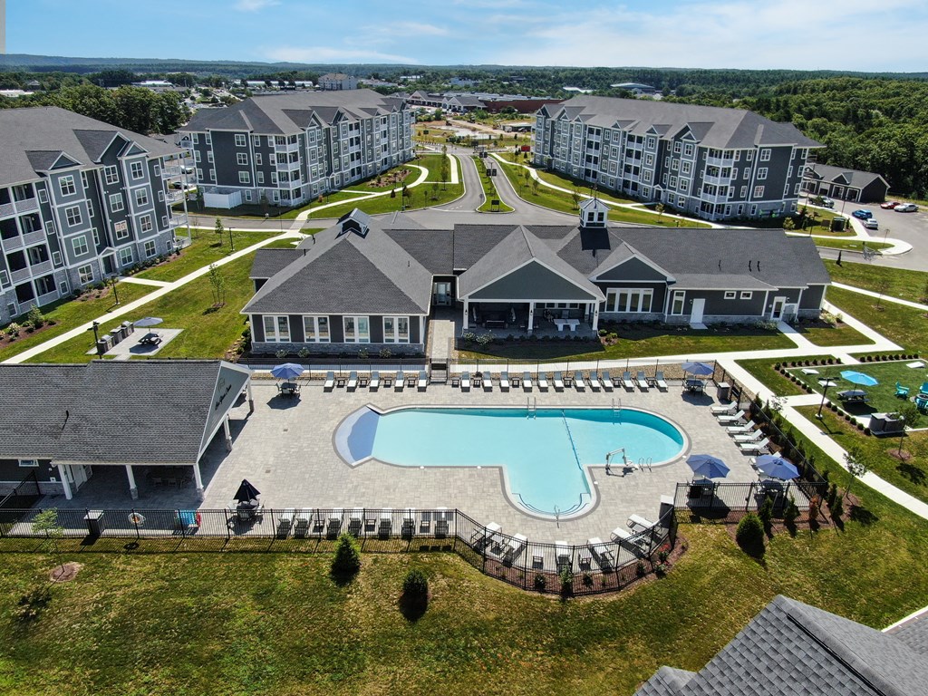 an aerial view of an apartment complex with a swimming pool